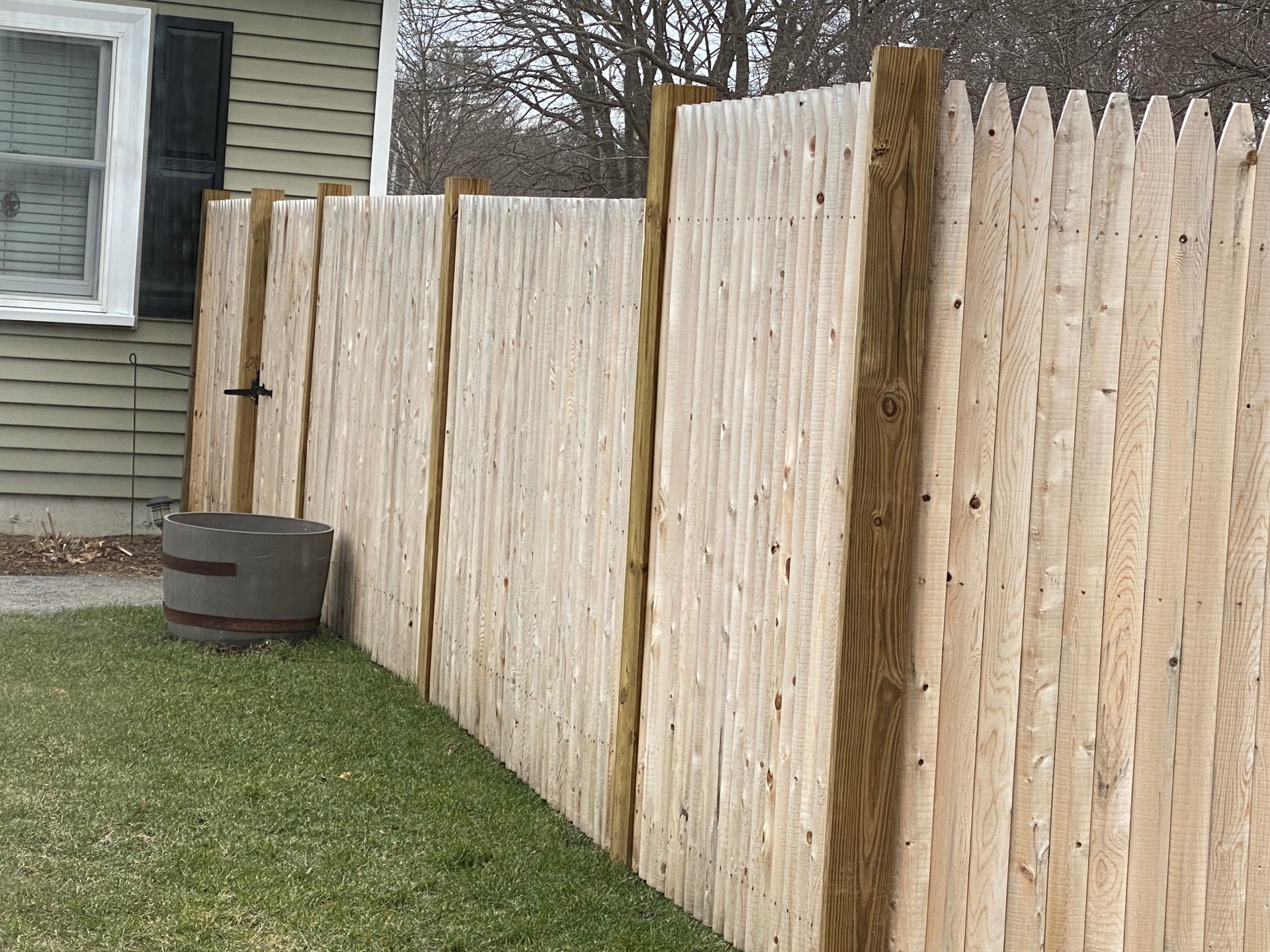 New stockade cedar privacy fence along the side of a home
